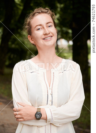 Portrait of a smiling girl outdoors, demonstrating beautiful teeth with braces Portrait of a smiling girl outdoors, demonstrating beautiful teeth with braces 74621793