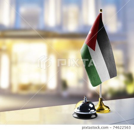 Jordan flag on the reception desk in the lobby of the hotel Jordan flag on the reception desk in the lobby of the hotel 74622563