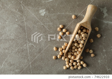 Scoop with fresh chickpea on gray background Scoop with fresh chickpea on gray background 74622910