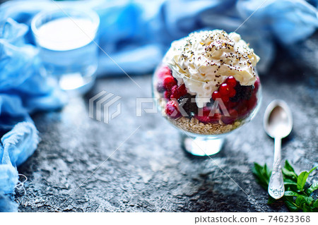 Recipe ideas for summer diet breakfast, healthy morning dessert in portioned jars with summer berries - raspberry, cherries, blackberry. On stone background Recipe ideas for summer diet breakfast, healthy morning dessert in portioned jars with summer berries - raspberry, cherries, blackberry. On stone background 74623368