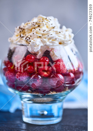 Recipe ideas for summer diet breakfast, healthy morning dessert in portioned jars with summer berries - raspberry, cherries, blackberry. On stone background Recipe ideas for summer diet breakfast, healthy morning dessert in portioned jars with summer berries - raspberry, cherries, blackberry. On stone background 74623369