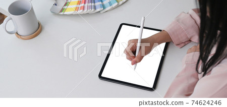 Horizontal photo of young woman graphic designer using stylus pen drawing on digital tablet. Horizontal photo of young woman graphic designer using stylus pen drawing on digital tablet. 74624246