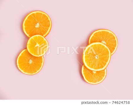 Orange slices frame on pink background with copy space. Empty place for text and product. Flatlay, top view. Orange slices frame on pink background with copy space. Empty place for text and product. Flatlay, top view. 74624758