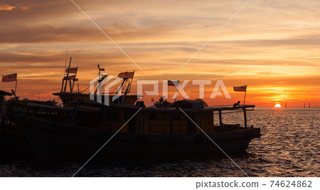 Silhouettes of fishing boats with flags, Malaysia Silhouettes of fishing boats with flags, Malaysia 74624862
