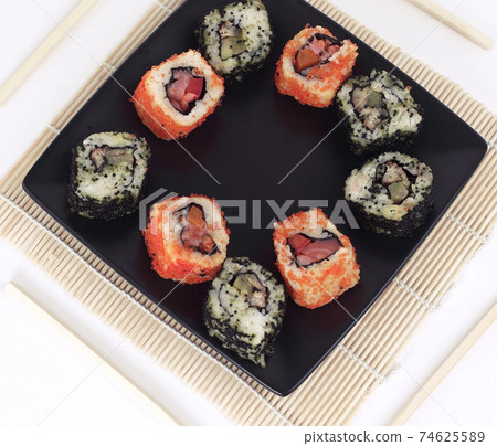different types of Maki sushi on a black plate different types of Maki sushi on a black plate 74625589
