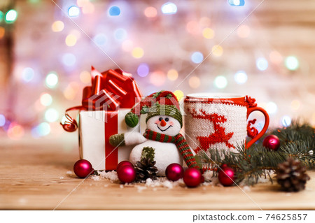 Cup with Christmas ornament,Christmas gifts and a cheerful snowm Cup with Christmas ornament,Christmas gifts and a cheerful snowm 74625857