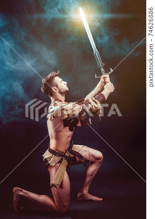 Portrait of angry warrior in leather clothes with swords Portrait of angry warrior in leather clothes with swords 74626886