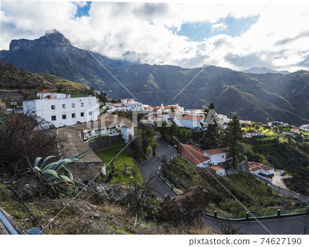 Picturesque Canarian village Tejeda in mountain valley scenery with road serpentine and view of Caldera de Tejeda Gran Canaria, Canary Islands, Spain 74627190