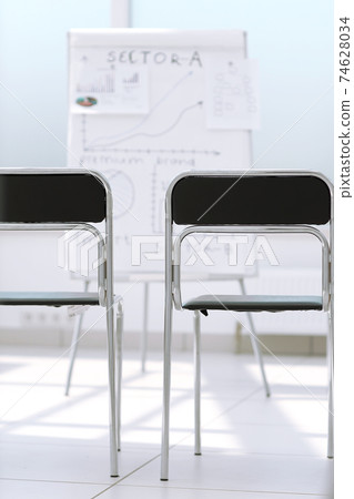 row of chairs in the conference room. row of chairs in the conference room. 74628034