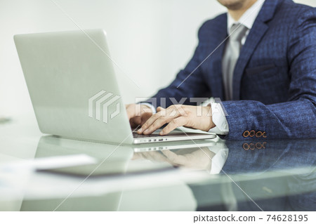 successful businessman working on laptop in the workplace. successful businessman working on laptop in the workplace. 74628195