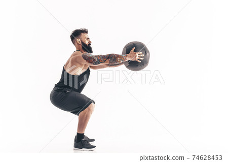 Muscular tattooed bearded male exercising fitness weights Medici Muscular tattooed bearded male exercising fitness weights Medici 74628453
