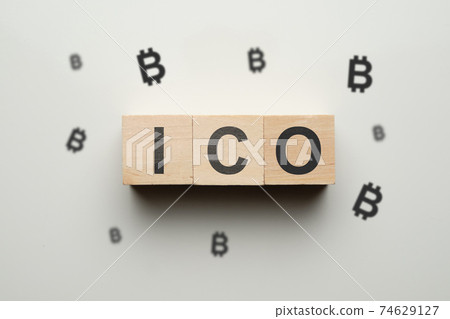 The concept of ico and cryptocurrency - wooden cubes with bitcoin. The concept of ico and cryptocurrency - wooden cubes with bitcoin. 74629127
