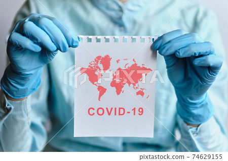 The concept of coronavirus covid-19 worldwide and the doctor is holding a piece of paper with graphics. 74629155