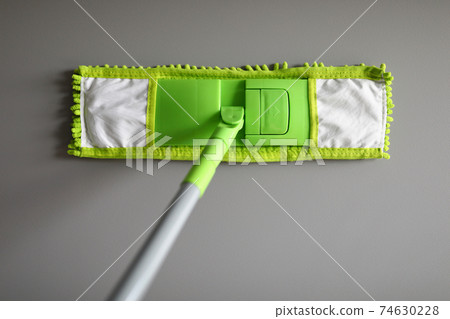Plastic mop with green microfiber cloth closeup Plastic mop with green microfiber cloth closeup 74630228