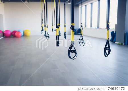 Fitness straps for working with own weight in gym, no people 74630472