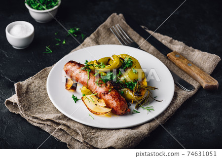 Oven baked pork sausage with bell peppers, onions and different herbs Oven baked pork sausage with bell peppers, onions and different herbs 74631051