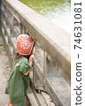 Child staring at the river 74631081