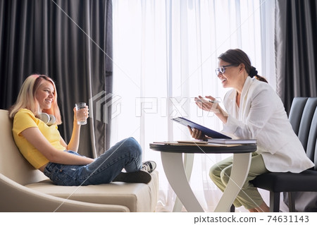 Female psychologist counseling teenage girl in office Female psychologist counseling teenage girl in office 74631143