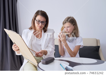 Professional counseling for children, psychologist looks at childs drawing Professional counseling for children, psychologist looks at childs drawing 74631242