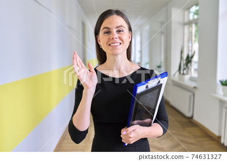 Close up portrait of young business woman talking and gesturing looking at camera Close up portrait of young business woman talking and gesturing looking at camera 74631327