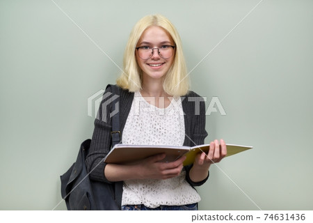 Portrait of happy student girl teenager 16 years old in glasses with backpack 74631436