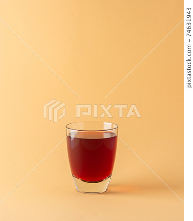 Sweet red pomegranate juice in glass 74631943
