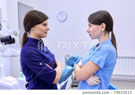 Team of two doctors women dentists in the dental office Team of two doctors women dentists in the dental office 74633015