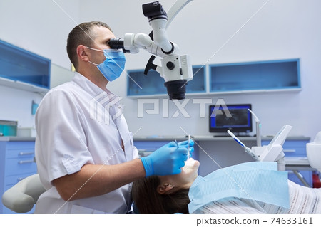 Healthcare dentistry medicine, male doctor dentist treating teeth 74633161