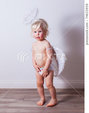 the baby with angel wings and nimbus indoors 74633939