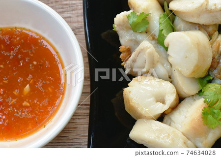 fried squid egg or gonad with chop fresh cabbage on plate dipping spicy and sour sauce 74634028