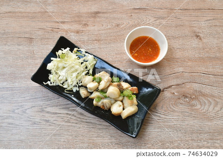 fried squid egg or gonad with chop fresh cabbage on plate dipping spicy and sour sauce fried squid egg or gonad with chop fresh cabbage on plate dipping spicy and sour sauce 74634029