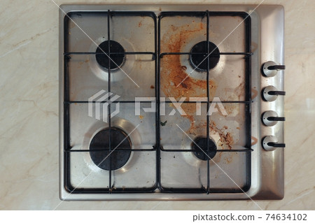 Dirty stove in a kitchen 74634102