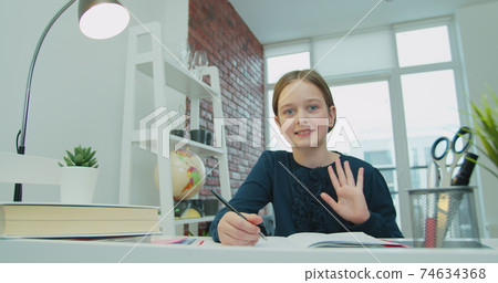 Happy child kid girl waving raising hand talking with remote web teacher on social distance video conference call elearning class on computer. Distance Learning, e-education, e-Learning, homeschooling Happy child kid girl waving raising hand talking with remote web teacher on social distance video conference call elearning class on computer. Distance Learning, e-education, e-Learning, homeschooling 74634368