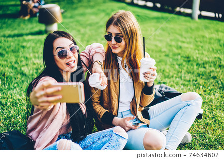 Stylish female bloggers in sunglasses publishing new posts on own websites Stylish female bloggers in sunglasses publishing new posts on own websites 74634602