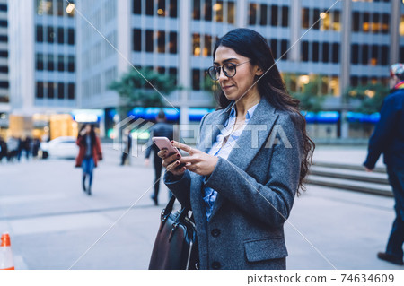 Ethnic female with smartphone in downtown in New York City Ethnic female with smartphone in downtown in New York City 74634609