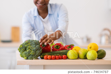 Unrecognizable Black Woman Cooking Vegetables Standing In Modern Kitchen, Cropped 74634787