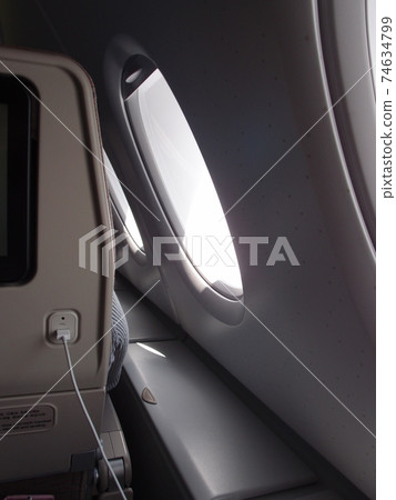 USB cable connected to the in-flight entertainment system USB cable connected to the in-flight entertainment system 74634799