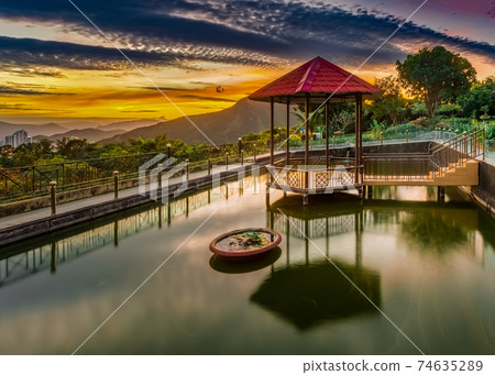 Pavilion on the pond at sunset 74635289