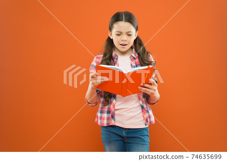 Shes a true bookworm. Adorable small child reading book Shes a true bookworm. Adorable small child reading book 74635699