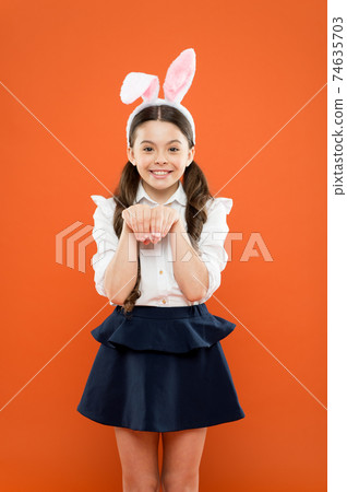 small girl wearing bunny ears on Easter day. Happy child small girl wearing bunny ears on Easter day. Happy child 74635703