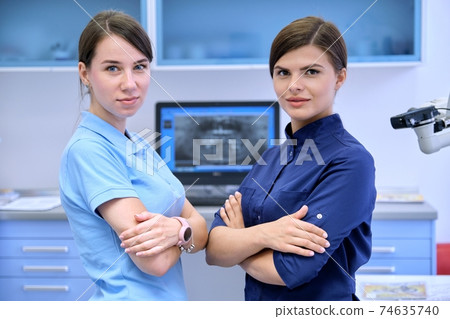 Team of two doctors women dentists in the dental office 74635740