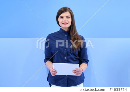 Medicine business portrait of young woman in blue uniform with digital tablet 74635754