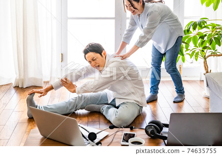 Young couple stretching during telework Young couple stretching during telework 74635755