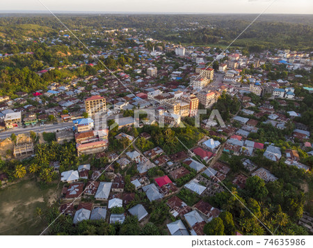 Aerial Drone shot of Chake Chake City, a Capital of Pemba island, Zanzibar archipelago. City in a river Delta at sunset time Aerial Drone shot of Chake Chake City, a Capital of Pemba island, Zanzibar archipelago. City in a river Delta at sunset time 74635986