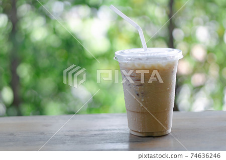 Close up glass of ice americano coffee on wood table, selective focus Close up glass of ice americano coffee on wood table, selective focus 74636246