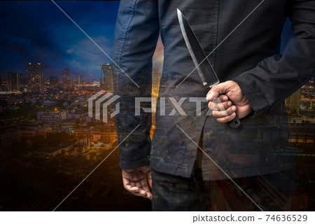 Businessman hold on knife 74636529