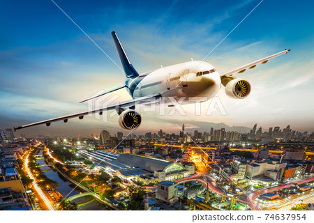 Airplane over city 74637954