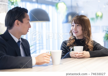 A couple talking in a cafe 74638027