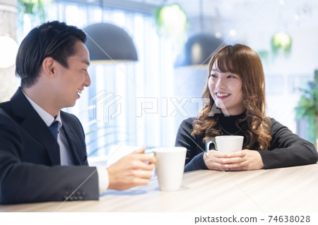 A couple talking in a cafe 74638028