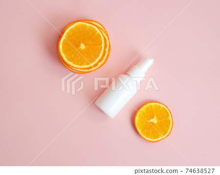 Top view and close-up of white plastic spray bottle mockup and orange slices on pink background. Natural organic spa cosmetics and liquid antimicrobial spray concept. 74638527